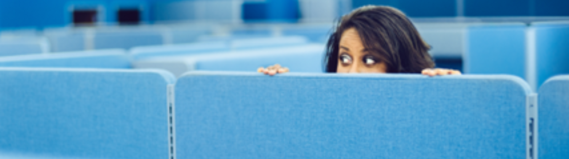  A woman hidden behind office cubicle